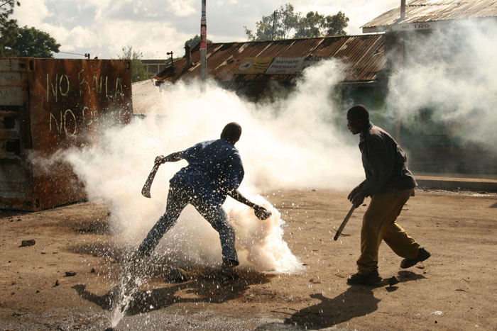 Tear gas : Demonstrators throw back tear gas to the police, Mathare slums, Nairobi, Kenya. This was the during the first day of the countrywide mass action that had been called by opposition leaders. © Julius Mwelu